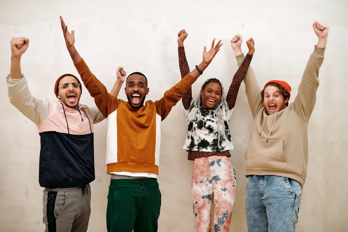 Free Multiracial People with Hands Raised  Stock Photo