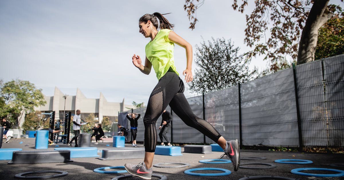 Woman in Green Tank Top and Black Leggings Doing Yoga