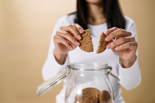 A Woman Breaking a Cookie