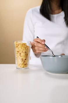 Close-up of a woman having breakfast with cereal and milk, promoting a healthy lifestyle.
