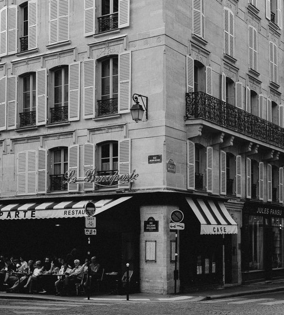 A classic Parisian café scene captured in charming black and white photography.