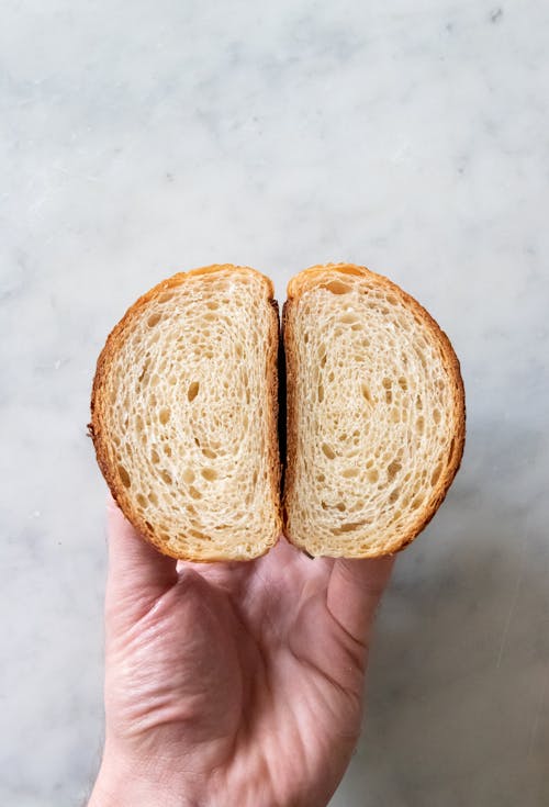 Free Hand Holding Pieces of Bread Stock Photo