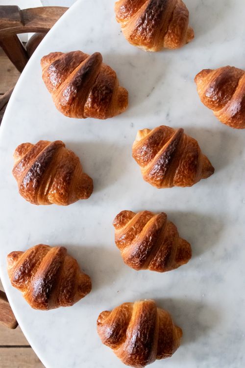 Free Delicious freshly baked croissants on a marble table, captured from above in London. Stock Photo