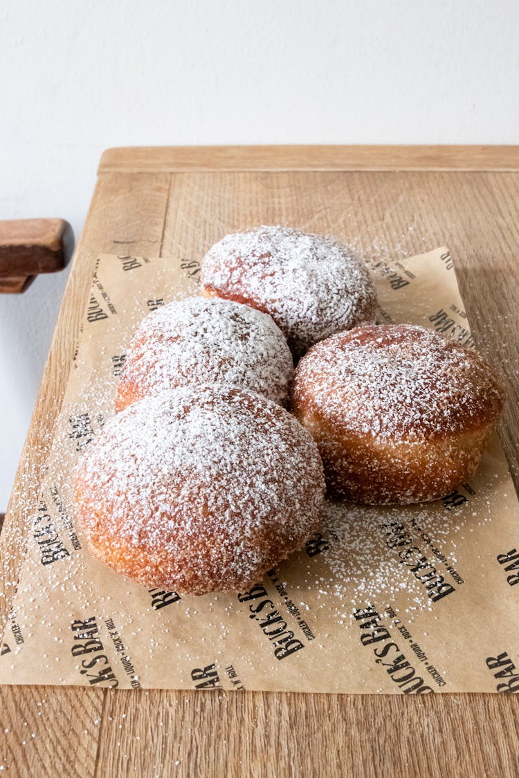 Powdered Donuts Lying On Baking Paper