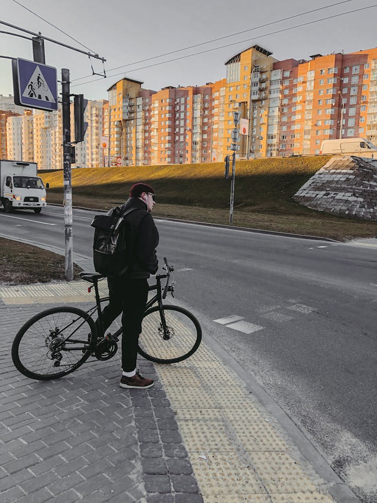 A Man Waiting Near Pedestrian Lane