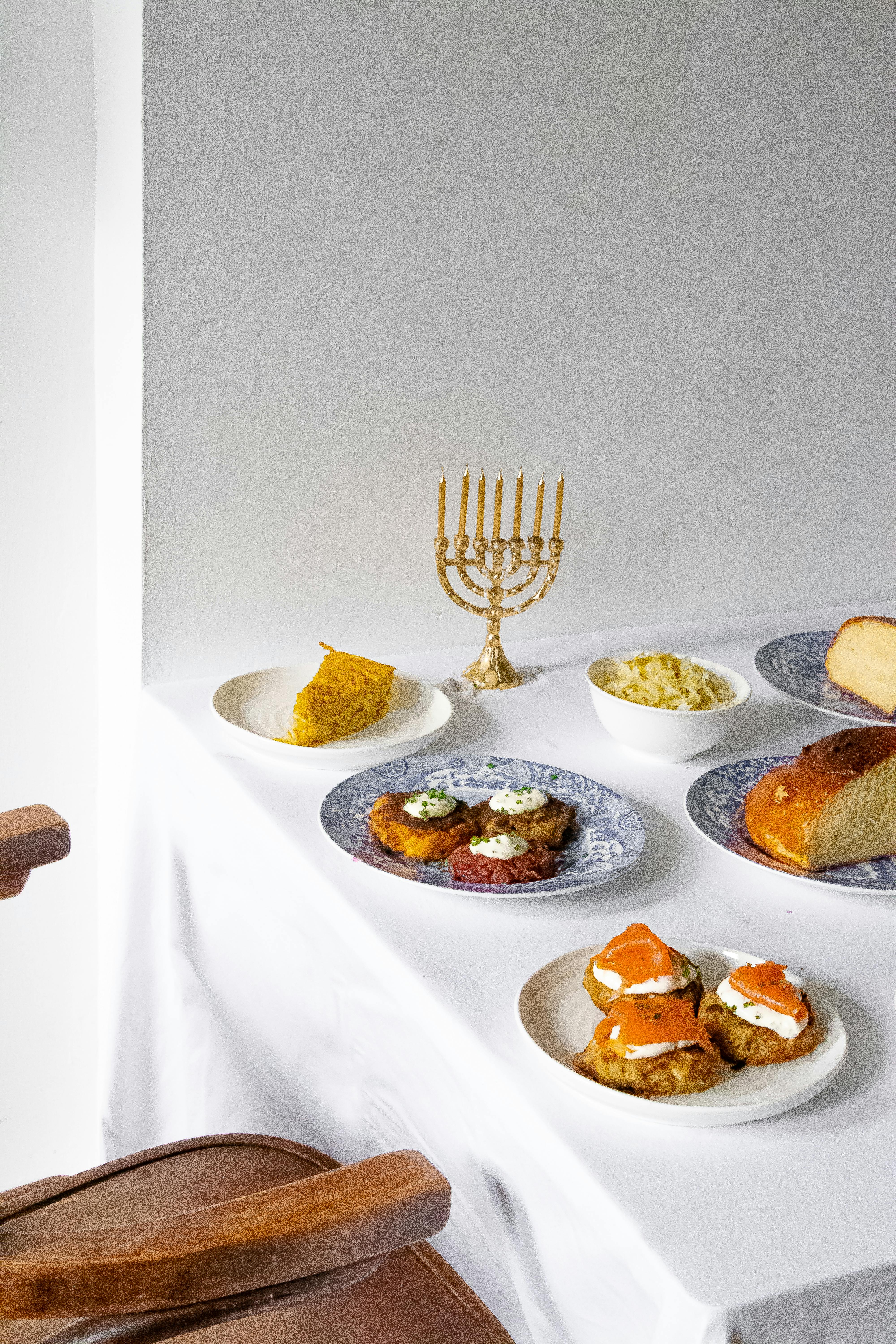 A festive table set with traditional Jewish dishes for Hanukkah celebration.