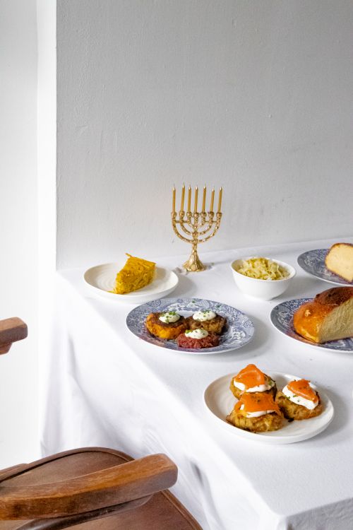 Free A festive table set with traditional Jewish dishes for Hanukkah celebration. Stock Photo