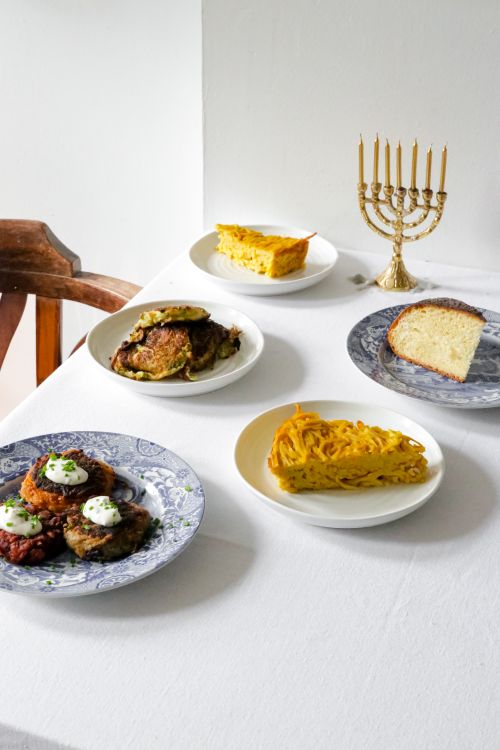 Free A festive Hanukkah table setup featuring traditional dishes and a menorah in London. Stock Photo