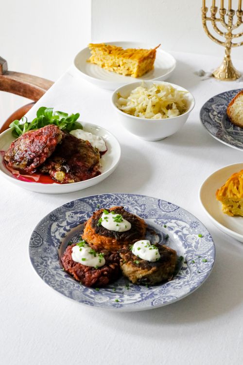 Free A table set for Hanukkah with traditional foods like latkes and kugel in London. Stock Photo