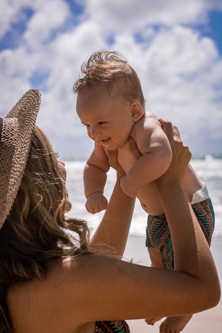 Happy Mom And Baby On Beach