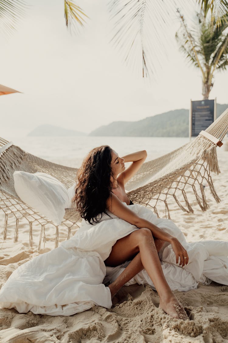 Woman Sitting Beside A Hammock