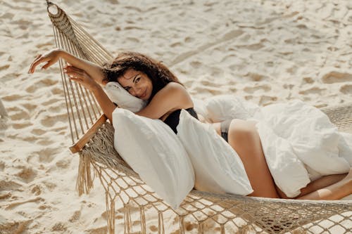 Free Woman in White Dress Lying on Brown Hammock Stock Photo