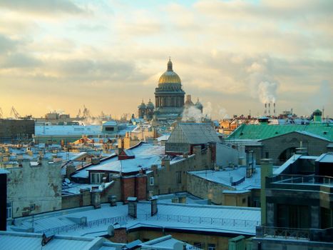 Scenic winter view of Saint Petersburg rooftops with the iconic St. Isaac's Cathedral in the background.