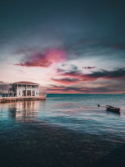 Free Beautiful sunset view of Istanbul's seaside with dramatic skies and tranquil sea. Stock Photo