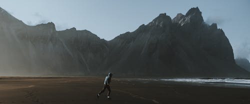 Người đàn ông Mặc áo Sơ Mi Trắng đi Dạo Trên Bãi Biển