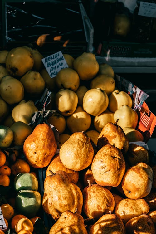 From above of yellow quince and pears placed in local market of town