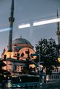 Aged mosque on street with bus in late evening