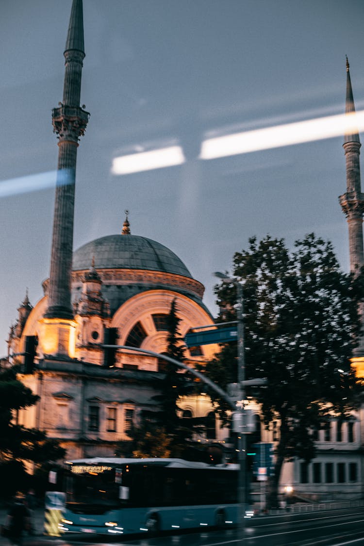 Aged Mosque On Street With Bus In Late Evening