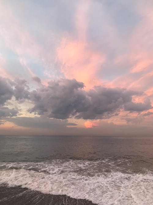 Pink Sky and Clouds Above the Sea