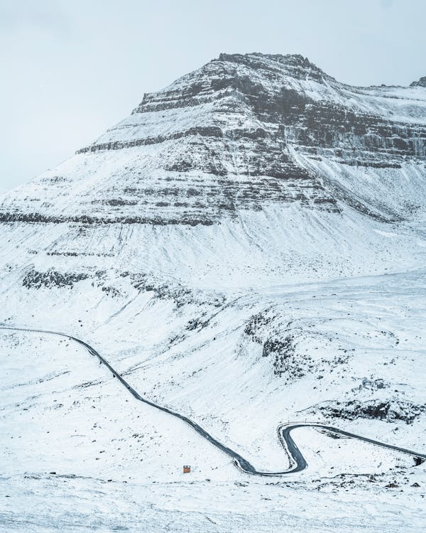 Free Snowy mountain ridge with long road Stock Photo