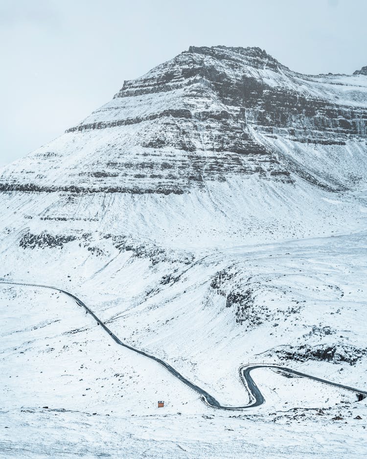 Snowy Mountain Ridge With Long Road