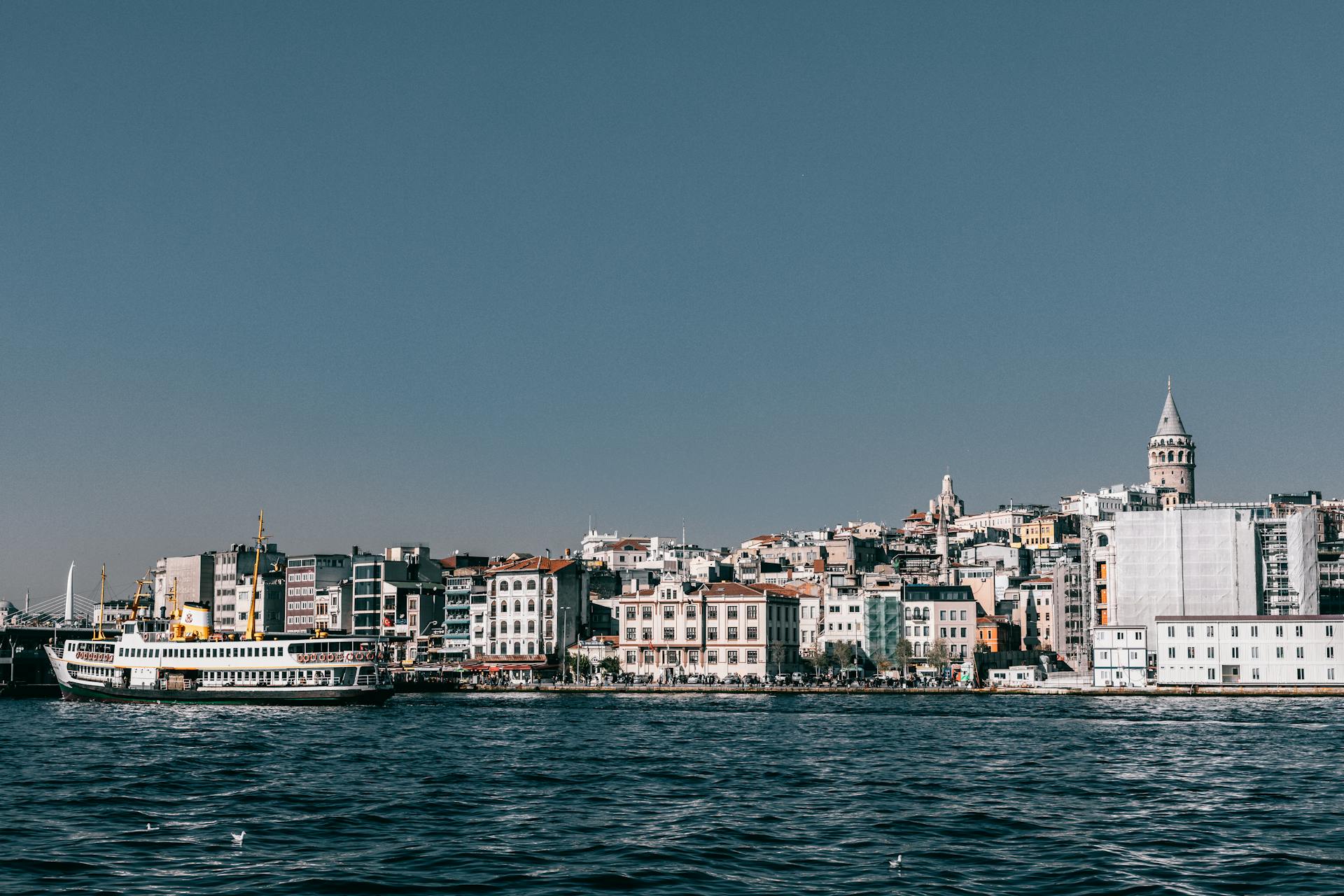 A stunning coastal view of Istanbul featuring the iconic Galata Tower by the Bosphorus Strait.