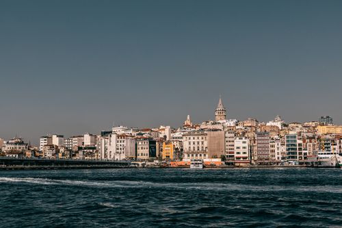 Free Rippling water of Bosphorus bay with Galata bridge and residential buildings with tower on background in Istanbul city against blue sky Stock Photo