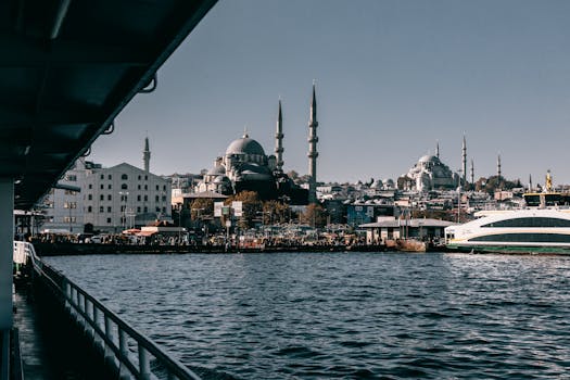 View of Istanbul's waterfront with iconic mosque and ferry, capturing the city's vibrant culture and architecture.