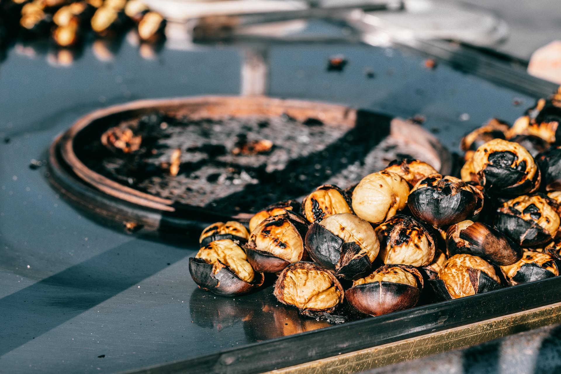 Grilled chestnuts on table in street