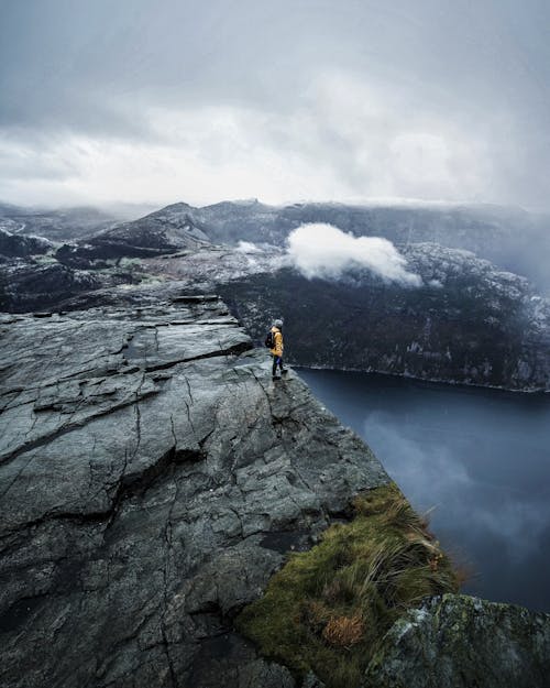 Unrecognizable traveler standing on mountain range