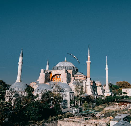 Wonderful Hagia Sophia grand mosque with tall minarets and dome located in Istanbul in Turkey against blue sky in city
