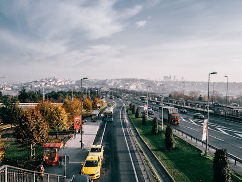 Multiple lane highway with driving vehicles located in Istanbul city suburb area on autumn day