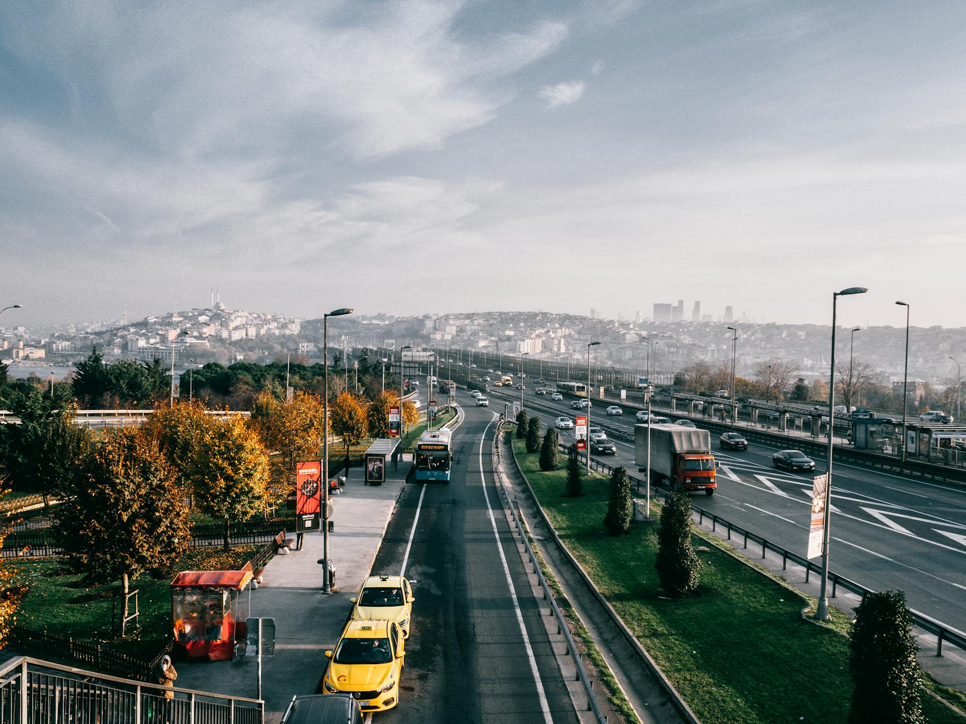 Multiple lane highway with driving vehicles located in Istanbul city suburb area on autumn day