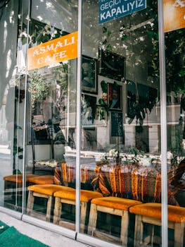 Charming view through cafe window in Istanbul with vibrant decor and reflections.