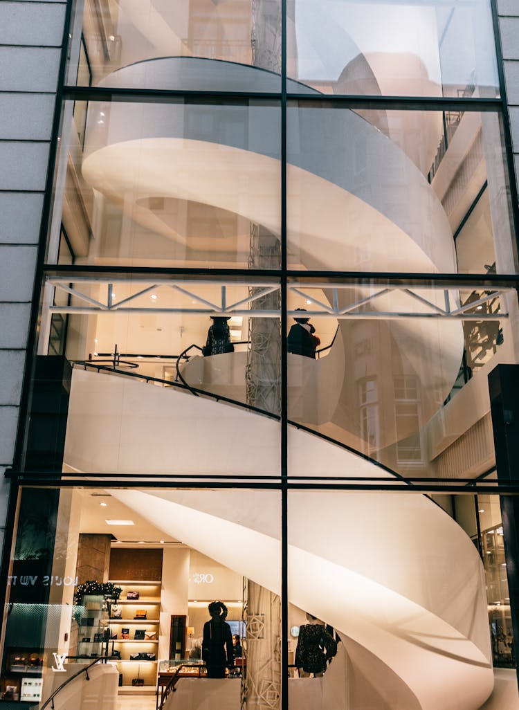 Through Glass Wall Spiral Stairs In Modern Building