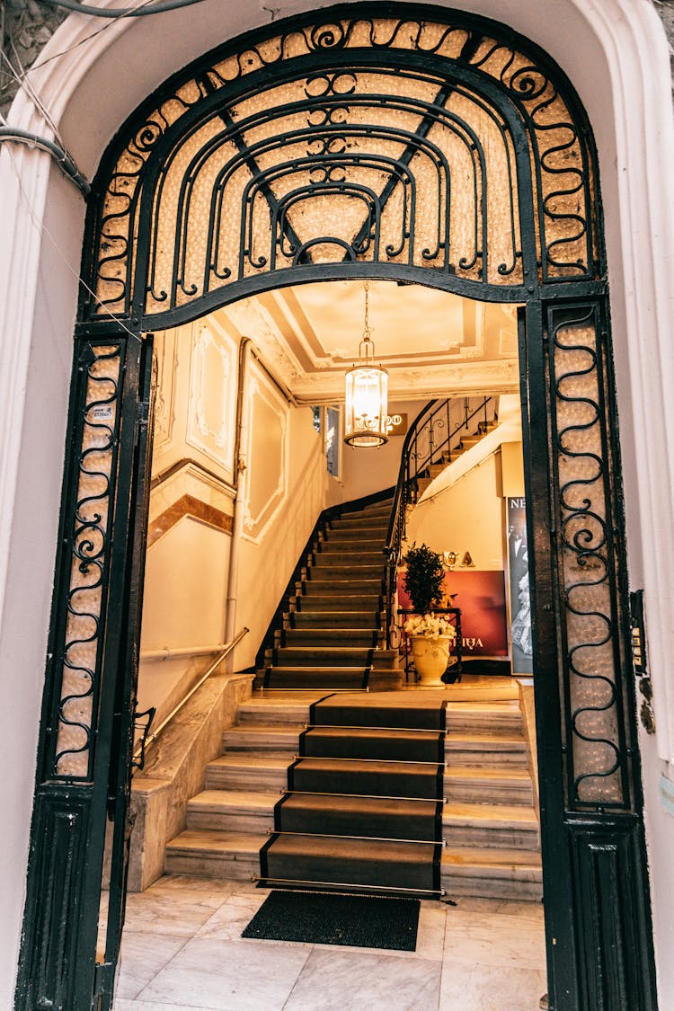 Grand Mansion Staircase Near Ornamental Entrance