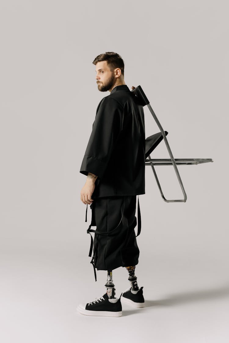 A Man Carrying A Chair