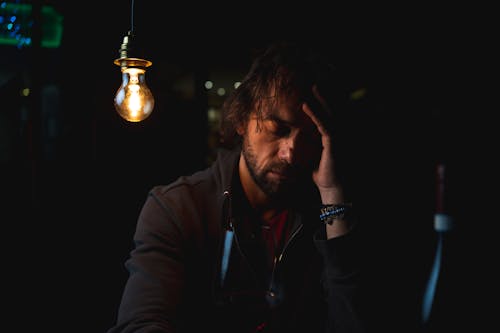 

A Bearded Man beside a Light Bulb