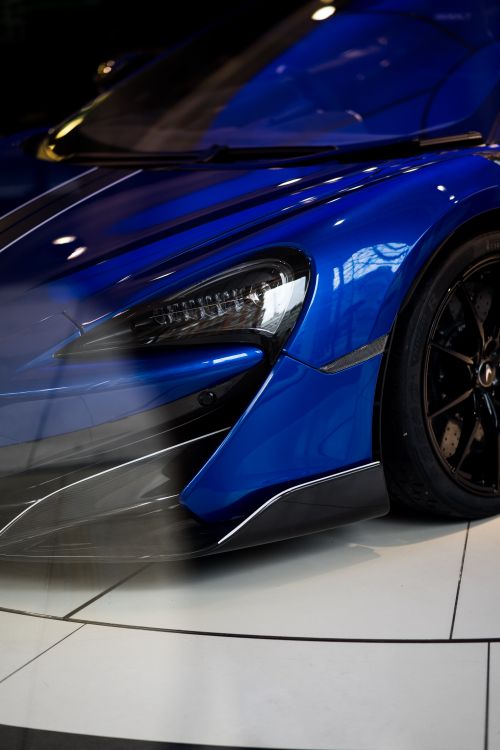 Free Detailed close-up of a sleek blue supercar displayed indoors in a London showroom. Stock Photo