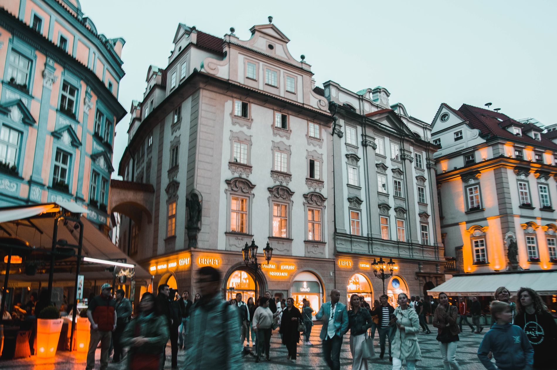 Historic Prague street with travellers walking through the city centre