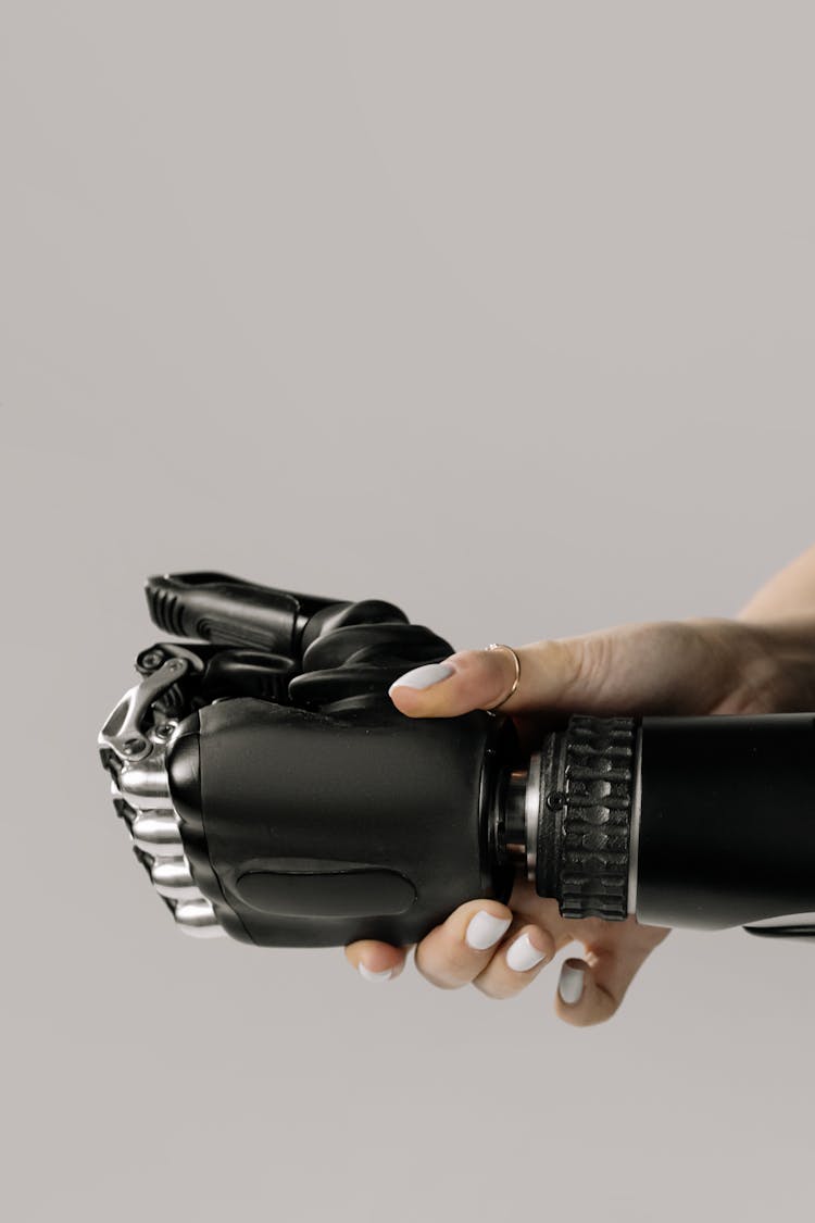 Close-Up Shot Of A Person Holding A Prosthetic Hand