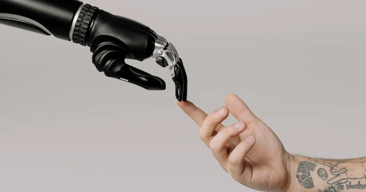 A black bionic hand touching a tattooed human finger, representing trade secret protection in AI companies