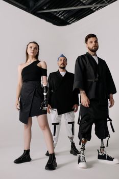 Group of models showcasing modern prosthetic fashion indoors.