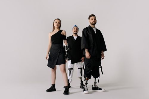 Free Diverse group showcasing prosthetic limbs in modern fashion on a white backdrop. Stock Photo