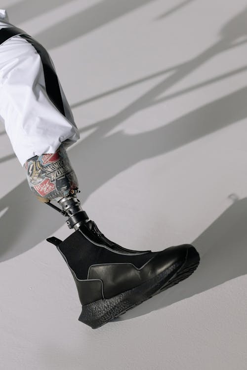 A Person Wearing Black Leather Boots