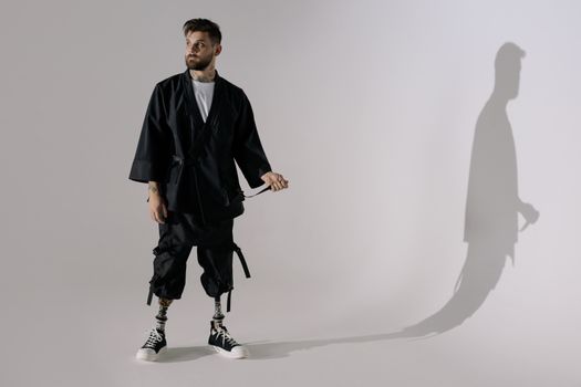 Man in Black Blazer and Black Pants Standing on White Floor