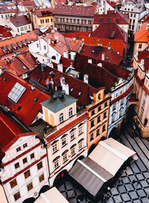 From above of exterior of old residential houses located near historic square in European city