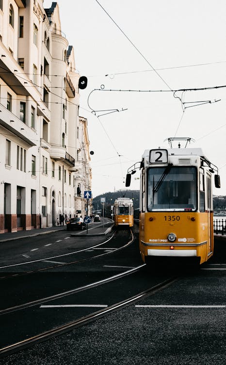 Free Modern tramway riding on railroad on embankment near classic buildings in European city Stock Photo