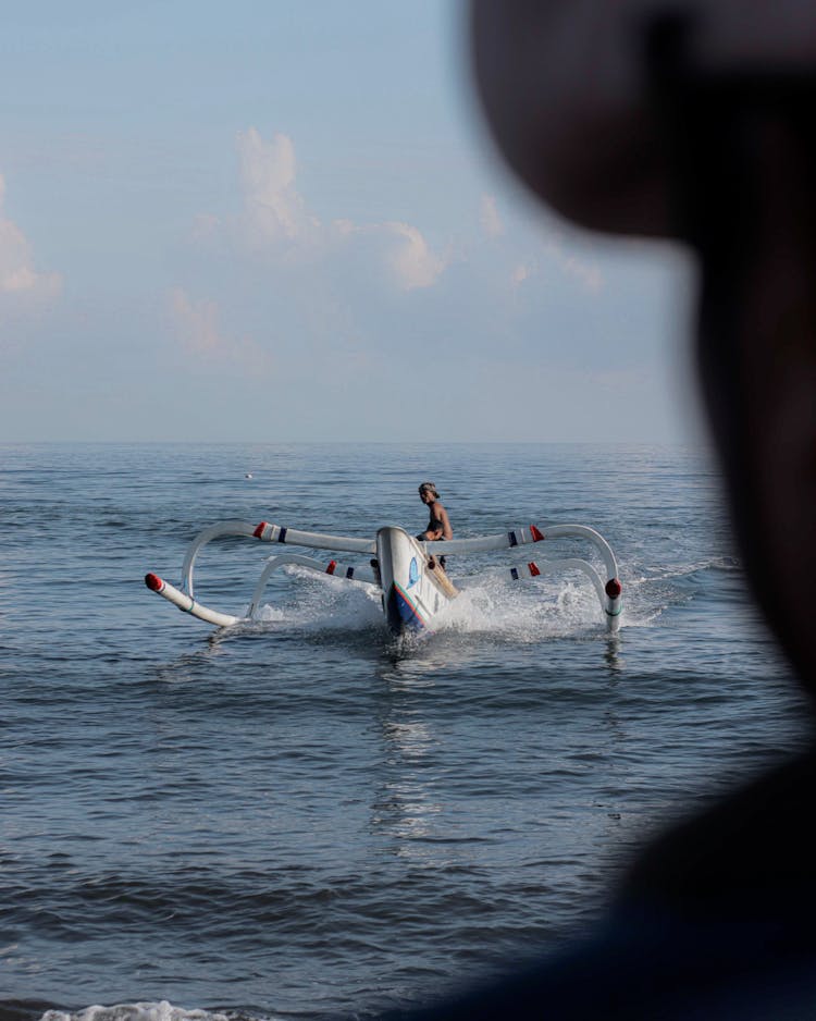 Outrigger Boat Floating On Sea