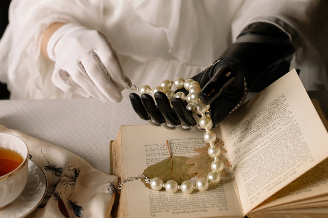 Free Person Wearing Gold Ring and White Pearl Bracelet Stock Photo